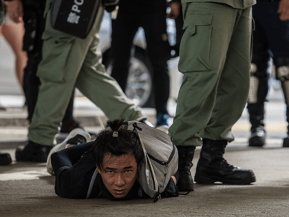 Riot police detain a man as they clear protesters taking part in a rally against a new national security law in Hong Kong on July 1, 2020, on the 23rd anniversary of the city's handover from Britain to China. - Hong Kong police made the first arrests under Beijing's new …