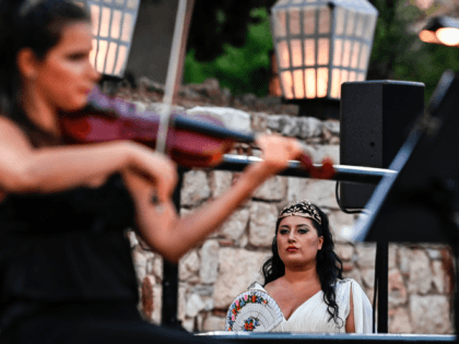Georgian mezzo-soprano Anita Rachvelishvili (R) looks on during a concert organised by the Greek National Opera at the ancient Roman Agora in Athens on July 18, 2020. - Following long months of coronavirus lockdown that has left music venues, opera houses and concert halls silent across the globe, the Greek …