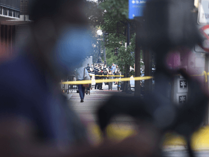 Police tape is seen behind a news camera on Pennsylvania Avenue near the White House in Washington, DC, on August 10, 2020, after Secret Service guards shot a person, who was apparently armed, outside the White House. - US President Donald Trump was abruptly ushered out of a press event …