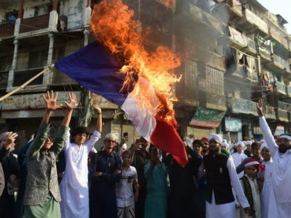 TOPSHOT - Pakistani Sunni Muslims burn a French flag during a protest in Karachi on Octob