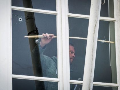 A technician takes measures of a window with bullet holes at the Embassy of Saudi Arabia in The Hague, after it has been shot at on November 12, 2020. - Several shots were fired at the Saudi embassy in the Dutch city of The Hague but no one was hurt, …