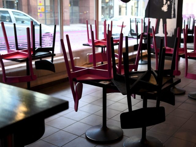 Chairs are placed on the tables at the closed Naughty BRGR restaurant that is serving only