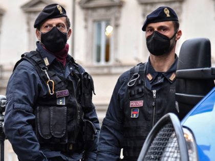 State Police officers stand guard outside the Palazzo Chigi government building (Rear) as police gets prepared prior to a demonstration of restaurant owners and workers, entrepreneurs and small businesses owners on April 12, 2021 in Rome, demanding the easing of lockdown restrictions and financial assistance from the government, during the …