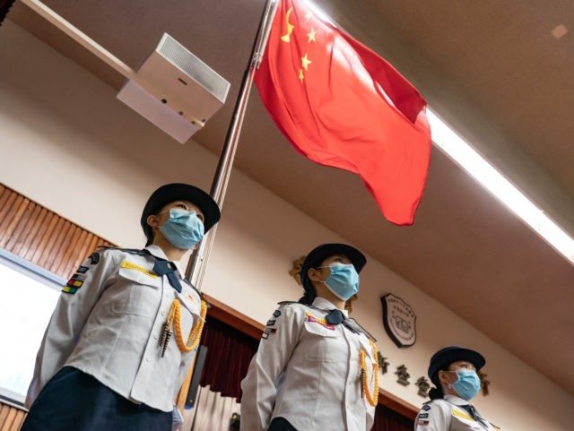 HONG KONG, CHINA - APRIL 15: Youth units of Association of Hong Kong Flag-guards stand guard in front of the Chinese national flag during a ceremony marking the National Security Education Day at the Hong Kong Federation of Education Workers Wong Cho Bau Secondary School on April 15, 2021 in …