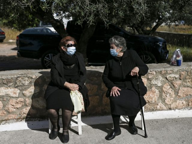 Two elderly women sit outside the health center of Elafonissos after being vaccinated against the Covid-19 (novel coronavirus), on the Elafonissos Island, on April 23, 2021. - Residents of the southern Greek island of Elafonissos received their covid vaccines, that will soon mark the destination as covid-free ahead of the …