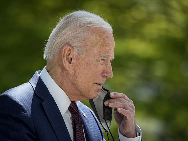 WASHINGTON, DC - APRIL 27: U.S. President Joe Biden removes his mask before speaking about