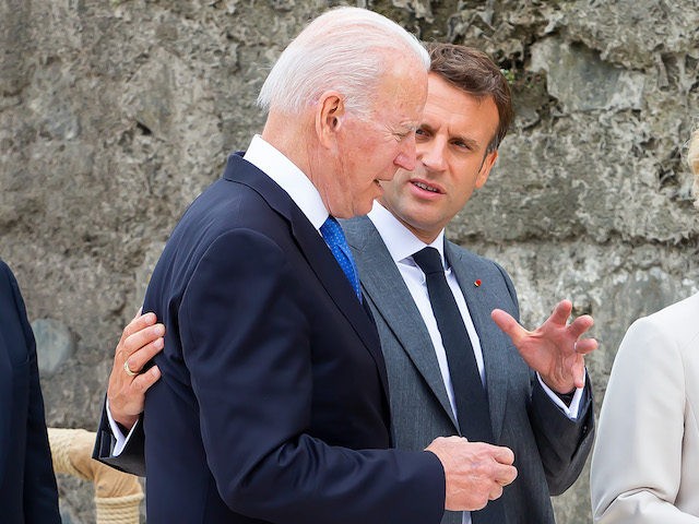 Joe Biden, president of US, walks with Emmanuel Macron, president of France. Political lea