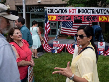 People talk before the start of a rally against "critical race theory" (CRT) being taught