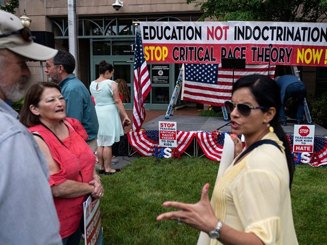 People talk before the start of a rally against "critical race theory" (CRT) being taught in schools at the Loudoun County Government center in Leesburg, Virginia on June 12, 2021. - "Are you ready to take back our schools?" Republican activist Patti Menders shouted at a rally opposing anti-racism teaching that critics like her say trains white children to see themselves as "oppressors." "Yes!", answered in unison the hundreds of demonstrators gathered this weekend near Washington to fight against "critical race theory," the latest battleground of America
