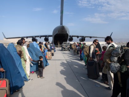 KABUL, AFGHANISTAN - AUGUST 24: In this handout provided by U.S. Central Command Public Affairs, U.S. Air Force loadmasters and pilots assigned to the 816th Expeditionary Airlift Squadron, load passengers aboard a U.S. Air Force C-17 Globemaster III in support of the Afghanistan evacuation at Hamid Karzai International Airport (HKIA) …