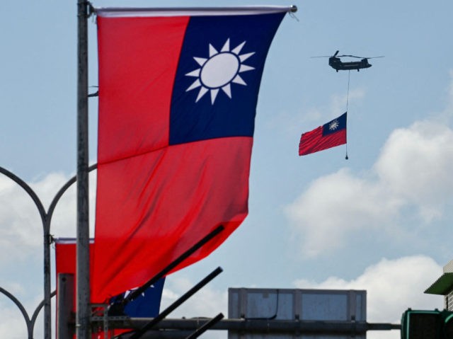 A CH-47 Chinook helicopter carries a Taiwan flag during national day celebrations in Taipei on October 10, 2021. (Photo by Sam Yeh / AFP) (Photo by SAM YEH/AFP via Getty Images)