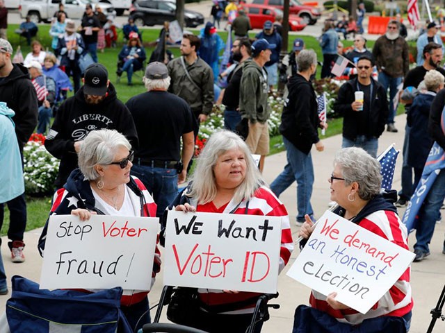 Protesters call for a "forensic audit" of the 2020 presidential election, during a demonstration by a group called Election Integrity Fund and Force outside of the Michigan State Capitol , in Lansing, on October 12, 2021. (Photo by JEFF KOWALSKY / AFP) (Photo by JEFF KOWALSKY/AFP via Getty Images)
