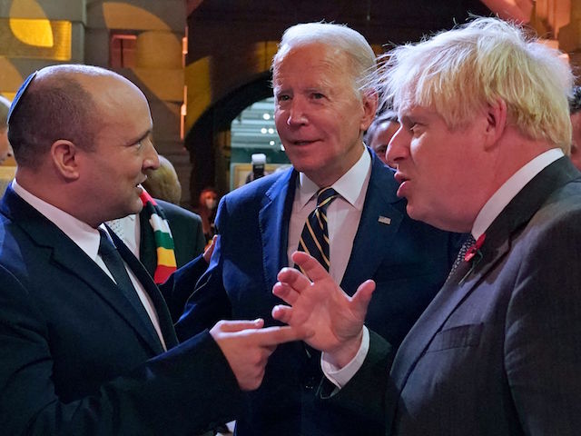 Israel's Prime Minister Naftali Bennett (L), US President Joe Biden (C) and British Prime Minister Boris Johnson (R) chat at a reception to mark the opening day of COP26 on the sidelines of the COP26 UN Climate Change Conference in Glasgow, Scotland on November 1, 2021. - COP26, running from October 31 to November 12 in Glasgow will be the biggest climate conference since the 2015 Paris summit and is seen as crucial in setting worldwide emission targets to slow global warming, as well as firming up other key commitments. (Photo by Alberto Pezzali / POOL / AFP) (Photo by ALBERTO PEZZALI/POOL/AFP via Getty Images)