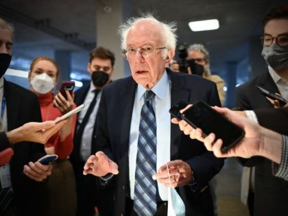 US Independent Senator Bernie Sanders speaks to reporters as he arrives at the US Capitol