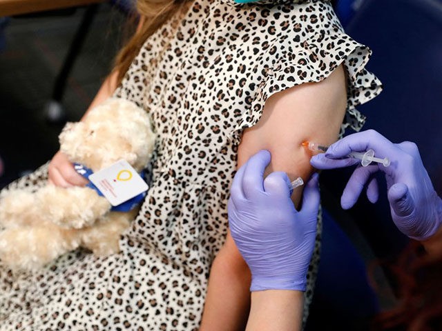 A 6 year-old child receives their first dose of the Pfizer Covid-19 vaccine at the Beaumont Health offices in Southfield, Michigan on November 5, 2021. (Photo by JEFF KOWALSKY / AFP) (Photo by JEFF KOWALSKY/AFP via Getty Images)
