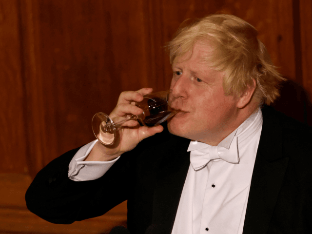 Britain's Prime Minister Boris Johnson drinks from a wine glass during the Lord Mayor's Banquet in central London on November 15, 2021. - The Lord Mayor's Banquet is held in honour of the outgoing Lord Mayor and is hosted by his successor the new Lord Mayor of the City of …