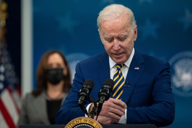 US President Joe Biden checks his watch before signing bills at the White House in Washington, DC, on November 30, 2021. (Photo by Jim WATSON / AFP) (Photo by JIM WATSON/AFP via Getty Images)