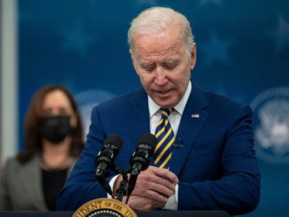 US President Joe Biden checks his watch before signing bills at the White House in Washington, DC, on November 30, 2021. (Photo by Jim WATSON / AFP) (Photo by JIM WATSON/AFP via Getty Images)