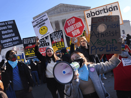 Abortion rights advocates and anti-abortion protesters demonstrate in front of the US Supreme Court in Washington, DC, on December 1, 2021. - The justices weigh whether to uphold a Mississippi law that bans abortion after 15 weeks and overrule the 1973 Roe v. Wade decision. (Photo by OLIVIER DOULIERY / …