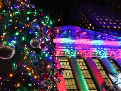 The facade of the New York Stock Exchange is lit up in Christmas colors during the 98th An