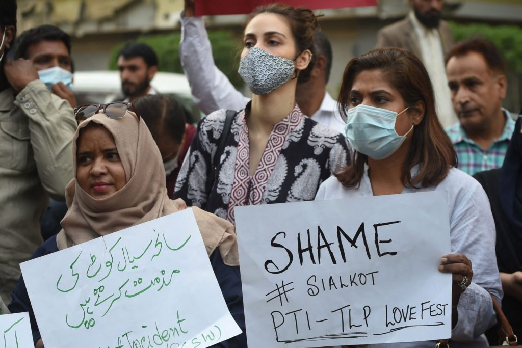 Members of Joint Action Committee carry placards during a protest in Karachi on December 4, 2021 against the killing of a Sri Lankan factory manager in Sialkot after he was beaten to death and set ablaze by a mob who accused him of blasphemy, officials said. (Photo by Rizwan TABASSUM / AFP) (Photo by RIZWAN TABASSUM/AFP via Getty Images)