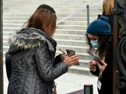 Visitors present their so-called "Green Pass" to be checked at the entrance to the Altare della Patria monument in Piazza Venezia on December 05, 2021 in Rome, as the city brought the obligation through December 04-31 to wear masks outdoors in the city centre and other busy shopping areas, in …