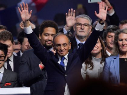 French far-right media pundit and 2022 presidential candidate Eric Zemmour (C) waves to supporters, flanked by French MP Joachim Son-Forget (L), adviser Sarah Knafo and Mouvement Conservateur leader Laurence Trochu, following the launch of his new party "Reconquete !" at the end of his campaign rally in Villepinte, near Paris, …