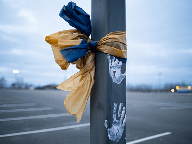 A ribbon is tied around a pole in the parking lot outside of Oxford High School on Decembe