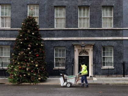 A City of Westminster worker cleans the street in front of 10 Downing Street, the official