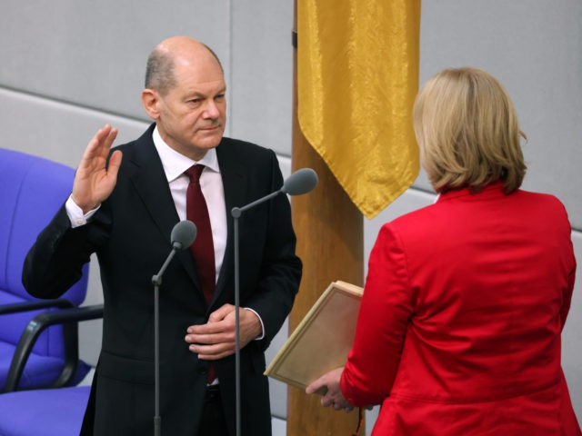 BERLIN, GERMANY - DECEMBER 08: New German Chancellor Olaf Scholz takes his oath of office from Bundestag President Baerbel Bas during a ceremony at the Bundestag, Germany's parliament, on December 08, 2021 in Berlin, Germany. The new German federal coalition government of German Social Democrats (SPD), Greens Party and German …