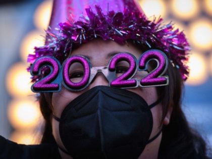 TOPSHOT - Teresa Hui poses for photos before the 2022 numerals to be used at a new year countdown event in Times Square in New York, on December 20, 2021. (Photo by Ed JONES / AFP) (Photo by ED JONES/AFP via Getty Images)
