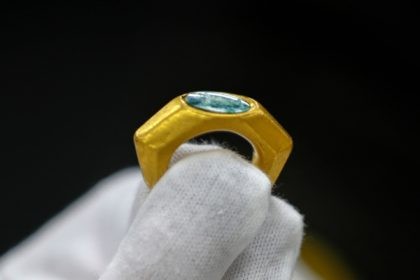 A gold ring bearing the symbol of the Good Shepherd, one of the earliest expressions to refer to Jesus, is displayed at the Israeli Antiquities Authority lab in Jerusalem on December 22, 2021. - Israel's maritime archaeologists found off the coast of Caesarea several precious artifacts, hundreds of silver coins …