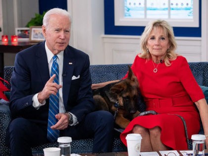 US President Joe Biden and US First Lady Jill Biden, with their new dog Commander, speak virtually with military service members to thank them for their service and wish them a Merry Christmas, from the South Court Auditorium of the White House in Washington, DC, on December 25, 2021. (Photo …