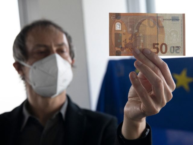 Eric Languillat, anti-counterfeiting expert at the Counterfeit Analysis Center of the European Central Bank (ECB) inspects a fifty Euros bill at The European Central Bank headquarters in Frankfurt am Main, western Germany, on December 22, 2021. - On the 23rd floor of the European Central Bank's towering Frankfurt headquarters, on …