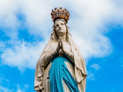 Statue of Our Lady in front of a cloudy sky