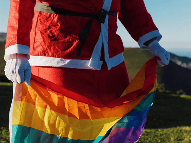 Santa holding pride flag