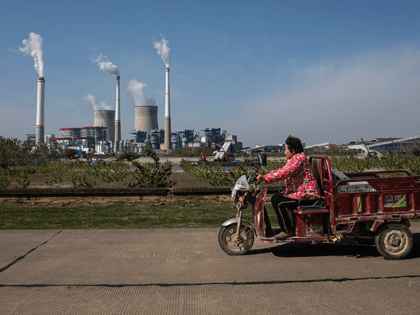 The resident cycling as coal fired power plant is in operation on November 11, 2021 in Hanchuan, Hubei province, China. China and the United States on Wednesday released the China-U.S. Joint Glasgow Declaration on Enhancing Climate Action in the 2020s here at the ongoing COP26 to the United Nations Framework …