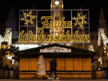 VIENNA, AUSTRIA - NOVEMBER 24: People walk past closed Christmas market stalls on Town Hal