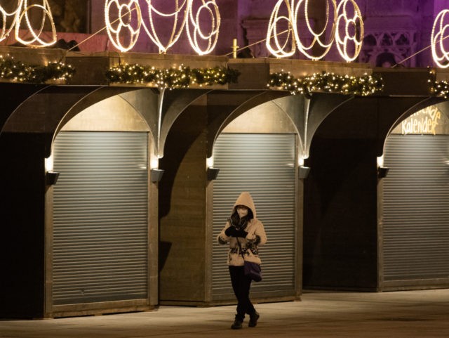 VIENNA, AUSTRIA - NOVEMBER 24: A person walks past closed Christmas market stalls on Steph