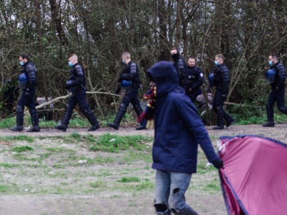 CALAIS, FRANCE - NOVEMBER 28: Police officers evict migrants from a camp on November 28, 2