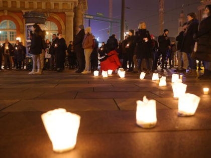 POTSDAM, GERMANY - DECEMBER 13: People protesting against vaccination mandates and coronavirus restrictions gather for a peaceful, candle-light vigil and march during the fourth wave of the novel coronavirus pandemic on December 13, 2021 in Potsdam, Germany. Similar protests have been taking place in dozens of towns and cities, mainly …