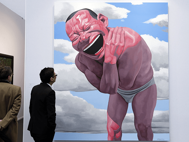A man looks at a painting by Chinese artist Yue Minjun known as "Blue sky and white clouds