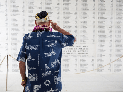 U.S.S. Arizona survivor Lou Conter salutes the Arizona Remembrance Wall during a memorial