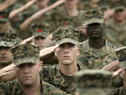 U.S. Marines and sailors of the 1MEF (1st Marine Expeditionary Force) salute the flag prio
