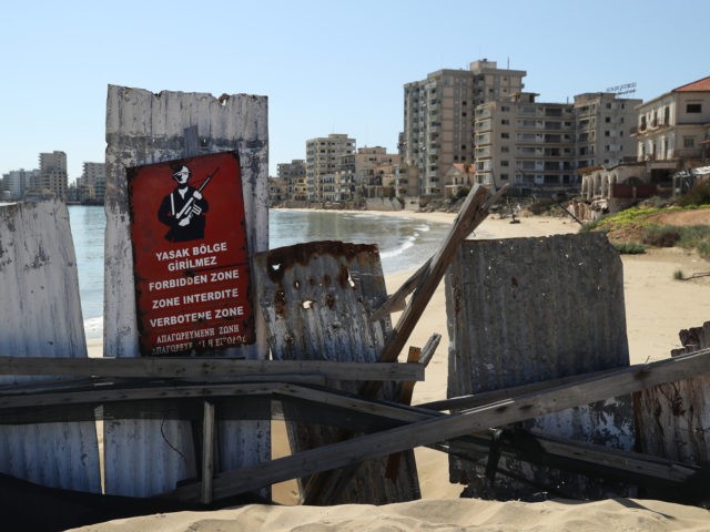 FAMAGUSTA, CYPRUS - MARCH 06: Former, decaying hotel buildings stand beyond a makeshift b