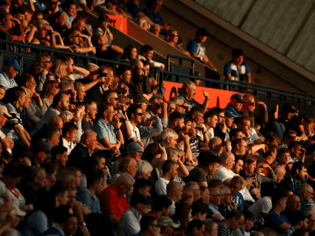 KILMARNOCK, SCOTLAND - JULY 13: Supporters look on in the late afternoon sunshine during t