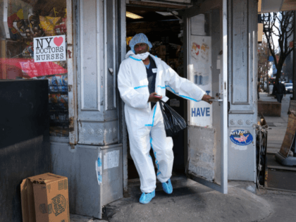 NEW YORK, NY - APRIL 09: An employee of a nearby hospital that has a special coronavirus intake area leaves a market in protective clothing on April 09, 2020 in the Brooklyn borough of New York City. Hospitals in New York City, which has been especially hard hit by the …