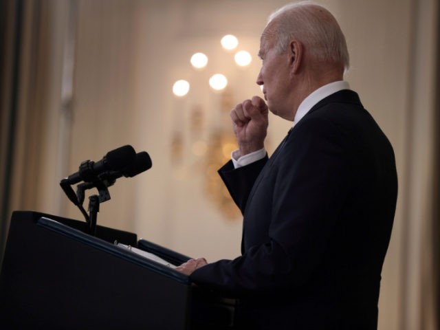 U.S. President Joe Biden coughs into his hand as he gives remarks on the November jobs report in the State Dining Room of the White House on December 03, 2021 in Washington, DC. According to the U.S. Labor Department, the economy added 210,000 jobs in November and the unemployment rate …