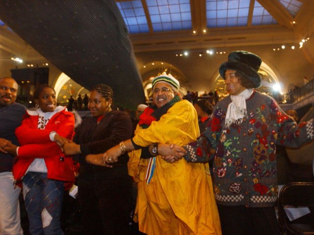 Akilah Young, 14, left, Davonne Hamilton, 11, both of the Bronx borough of New York, Hugh Stroud, of New York's Harlem neighborhood, and Marion Bowie, of New York'Brooklyn borough join hands during the annual Kwanzaa celebration at the Museum of Natural History, Sunday, Dec. 26, 2004, in New York. Kwanza, a celebration of family, community and culture, was established in 1966 by Dr. Maulana Karenga to reaffirm a common identity, purpose and direction for African-American people and their world African community. (AP Photo/Jennifer Szymaszek)