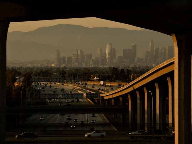 Vehicles drive on the 110 Freeway towards the Los Angeles skyline at the Judge Harry Prege